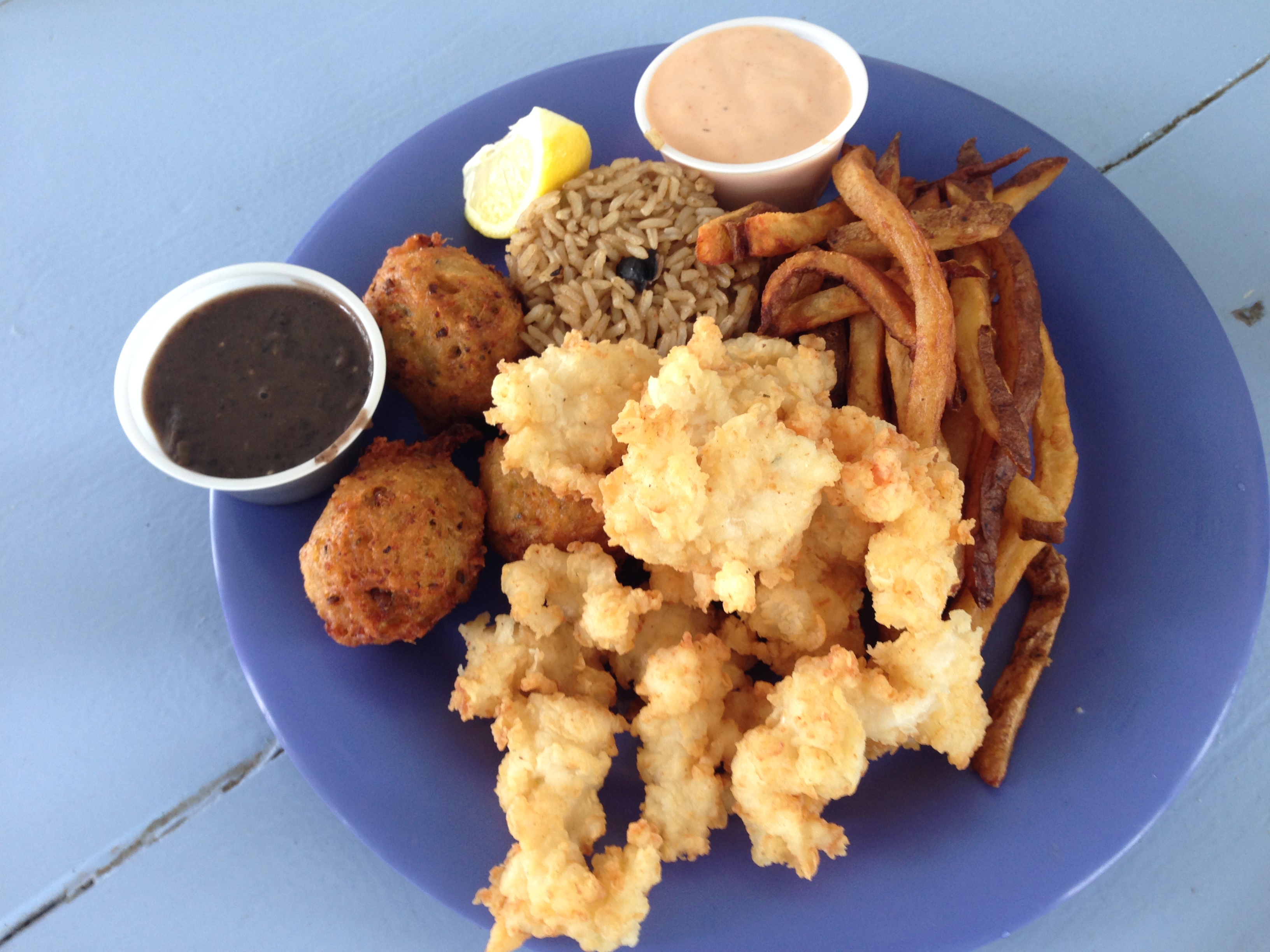 Conch Combo so much goodness. Cracked conch, conch fritters, peas & rice and Johnny fries